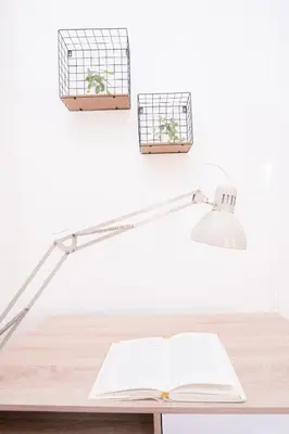 a desk with a lamp and an open book at Prague Days - Two-bedroom Apartment with Workspace right next to Old Town Square in Prague