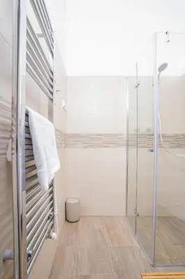 a bathroom with a shower and a glass shower stall at Prague Days - Two-bedroom Apartment with Workspace right next to Old Town Square in Prague