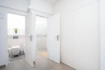 a white bathroom with a shower and a toilet at Prague Days - Two-bedroom Apartment with Workspace right next to Old Town Square in Prague