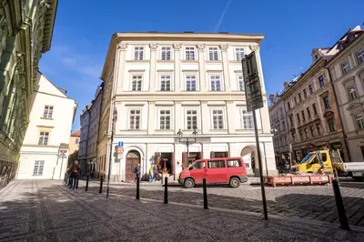 a red van parked in front of a building at Prague Days - Two-bedroom Apartment with Workspace right next to Old Town Square in Prague