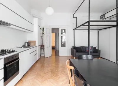 a kitchen and living room with a black counter top at Prague Days - Apartment with Chill Zone right next to Wenceslas Square in Prague