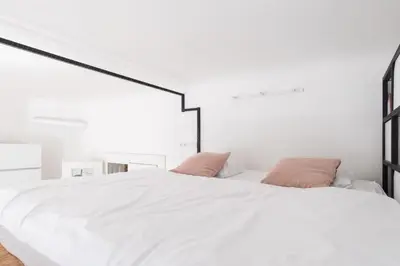 a bedroom with a large white bed with two pillows at Prague Days - Apartment with Chill Zone right next to Wenceslas Square in Prague