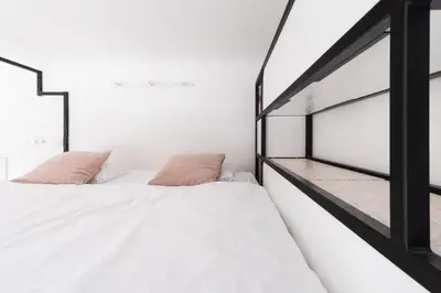 two beds in a bedroom with white walls at Prague Days - Apartment with Chill Zone right next to Wenceslas Square in Prague