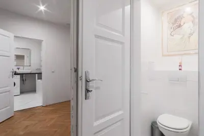 a white bathroom with a toilet and a sink at Prague Days - Apartment with Chill Zone right next to Wenceslas Square in Prague