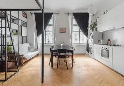 a dining room with a table and a kitchen at Prague Days - Apartment with Chill Zone right next to Wenceslas Square in Prague