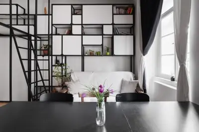 a table with a vase of flowers on it in a room at Prague Days - Apartment with Chill Zone right next to Wenceslas Square in Prague