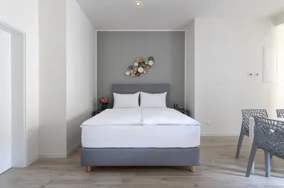 a bedroom with a bed and a table and chairs at Kinsky Garden Apartments and Suites by Dwellfort in Prague