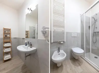 a bathroom with a sink and a toilet and a shower at Kinsky Garden Apartments and Suites by Dwellfort in Prague