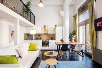 a living room with a white couch and a table at 2-level apartments on Krizikova near the metro in Prague