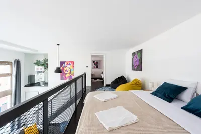 a bedroom with a bed and a balcony at 2-level apartments on Krizikova near the metro in Prague