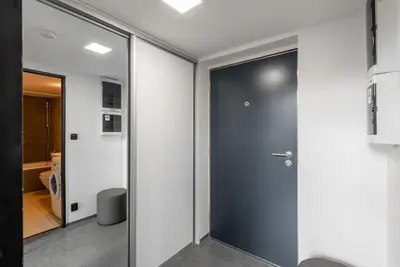 a glass door in a room with a hallway at 2-level apartments on Krizikova near the metro in Prague