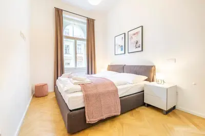 a bedroom with a bed and a window at Petrin Tower Residence in Prague