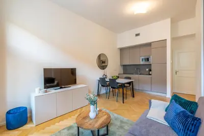 a living room with a couch and a table at Petrin Tower Residence in Prague