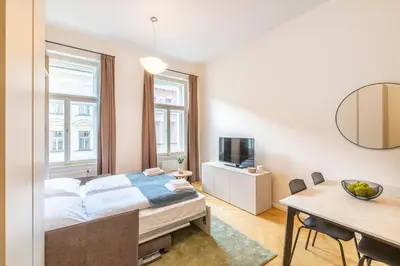 a bedroom with a bed and a dining table at Petrin Tower Residence in Prague