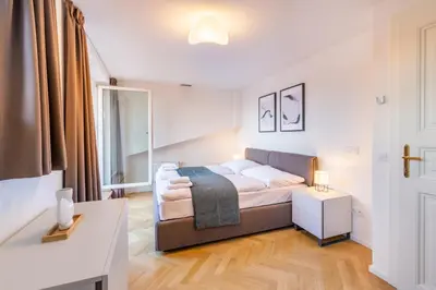 a small bedroom with a bed and a table at Petrin Tower Residence in Prague