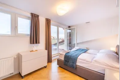 a bedroom with a bed and a window at Petrin Tower Residence in Prague