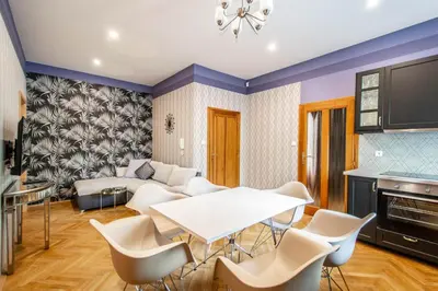 a living room with a white table and chairs at National Museum 3BDR Golden Stork Spot in Prague