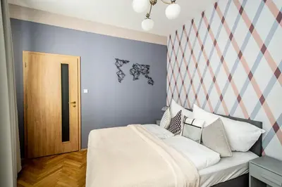 a bedroom with a bed with a striped wall at National Museum 3BDR Golden Stork Spot in Prague