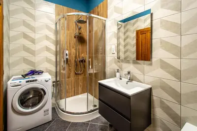 a bathroom with a washing machine and a sink at National Museum 3BDR Golden Stork Spot in Prague