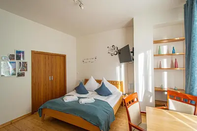 a bedroom with a bed with blue pillows at Bright Ruterra Apartment in the Heart of Prague in Prague