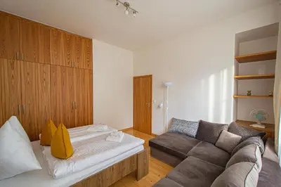 a living room with a couch and a couch at Bright Ruterra Apartment in the Heart of Prague in Prague