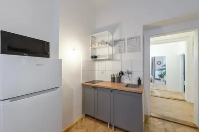 a kitchen with a white refrigerator and a sink at 2BDR Pretty Apartment in the Local Area of Prague in Prague