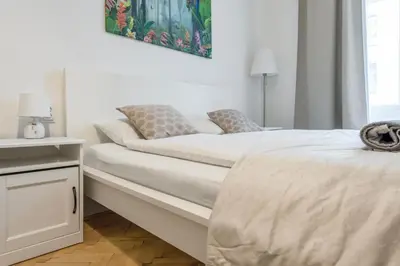a white bedroom with a bed and a window at 2BDR Pretty Apartment in the Local Area of Prague in Prague