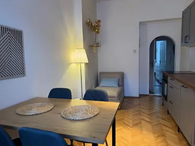 a kitchen and dining room with a table and chairs at 2BDR Pretty Apartment in the Local Area of Prague in Prague