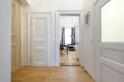 a hallway with a white door and a table at 2BDR Pretty Apartment in the Local Area of Prague in Prague