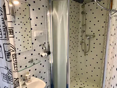 a bathroom with a shower and a sink at Sleep & Go Single Room in Prague