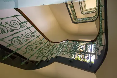 a spiral staircase with a wrought iron railing at Sleep & Go Single Room in Prague
