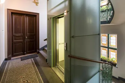 an entrance to a house with a door and a rug at Sleep & Go Single Room in Prague