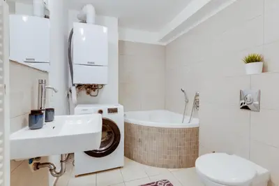 a bathroom with a sink and a toilet and a tub at Spacious stylish attic in the heart of the center - Karlovo in Prague