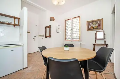 a dining room with a wooden table and black chairs at Classic Old town stay in Prague