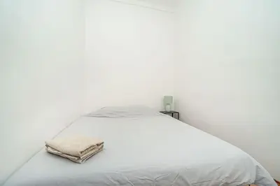 a white bed with two towels on top of it at Classic Old town stay in Prague