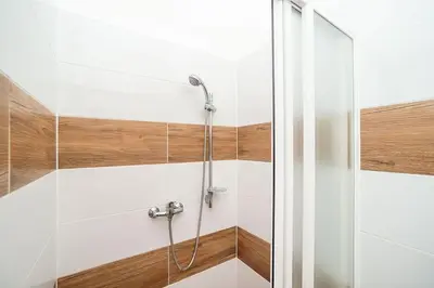a shower with a glass door in a bathroom at Classic Old town stay in Prague