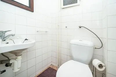 a white bathroom with a toilet and a sink at Classic Old town stay in Prague