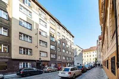 a city street with cars parked in front of buildings at Classic Old town stay in Prague