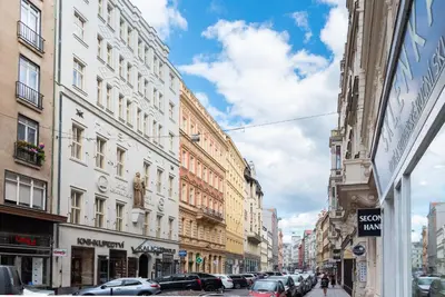 a city street with parked cars and buildings at Theatre 9 Apartments by Adrez in Prague
