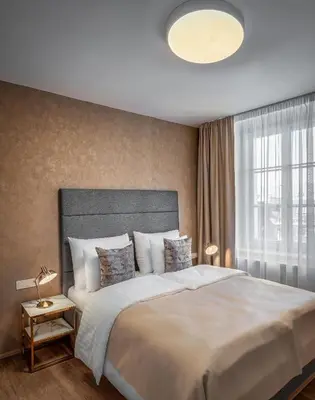 a bedroom with a large white bed and a window at Theatre 9 Apartments by Adrez in Prague