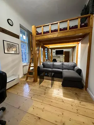 a living room with a couch and a loft bed at Cozy New Loft Apartment in Prague