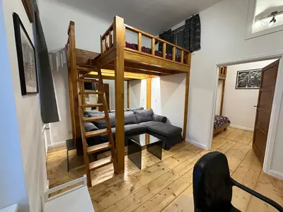 a living room with a loft bed and a couch at Cozy New Loft Apartment in Prague