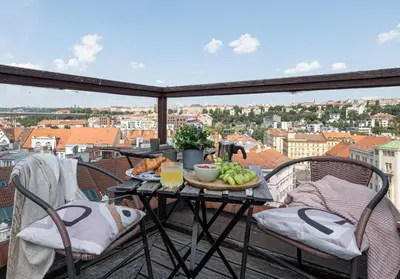 a balcony with a table with fruits and vegetables on it at Prague Days - Airy Duplex with Terrace and AC in Prague