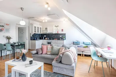 a living room with a couch and a table at Prague Days - Airy Duplex with Terrace and AC in Prague