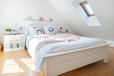 a bedroom with a white bed in a attic at Prague Days - Airy Duplex with Terrace and AC in Prague