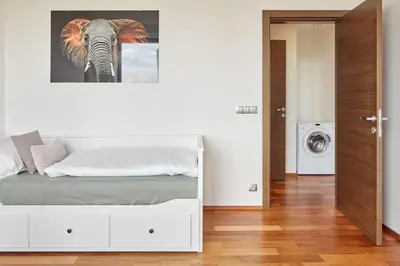 a bedroom with a bed with a painting of an elephant at Spacious Condo in Nusle by Prague Days in Prague