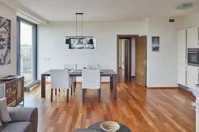a dining room with a table and white chairs at Spacious Condo in Nusle by Prague Days in Prague