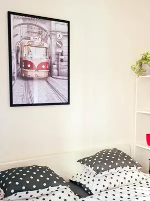 a bedroom with a picture of a tram at Modern apartment Krymská & Francouzská street in Prague