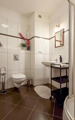 a bathroom with a toilet and a sink at Modern apartment Krymská & Francouzská street in Prague