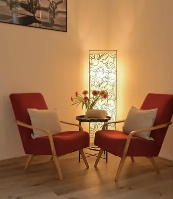 two red chairs and a table in a room at Modern apartment Krymská & Francouzská street in Prague